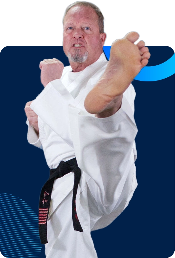 Man with a black belt kicking.