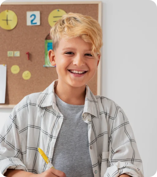 A blonde child, smiling.