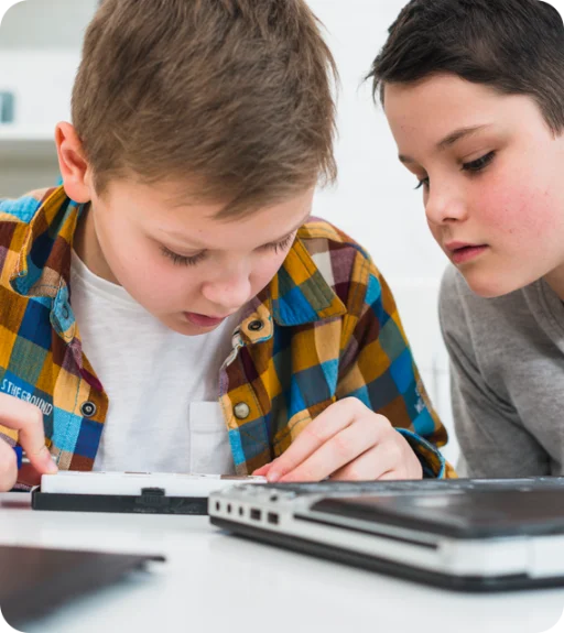 Two kids looking at a small screen.